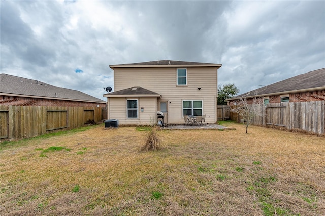 back of property featuring a yard and a patio