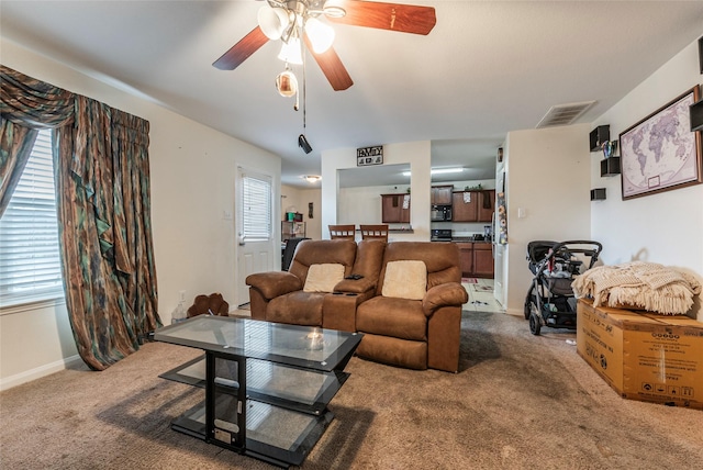 carpeted living room with ceiling fan