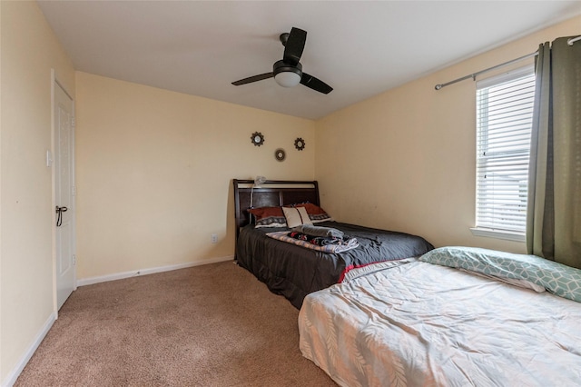 bedroom with ceiling fan, light carpet, and multiple windows