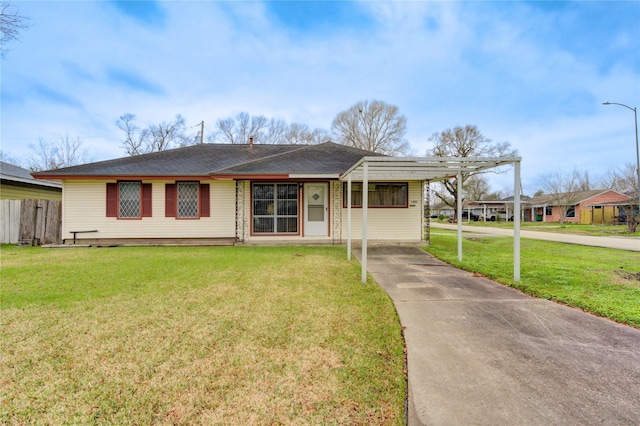 view of front of property with a carport and a front lawn