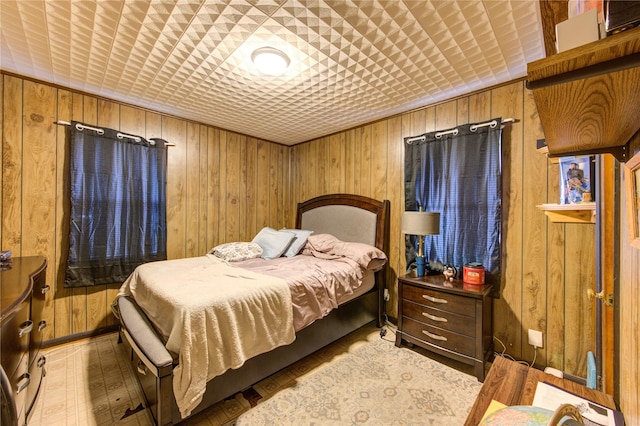 bedroom featuring wood walls