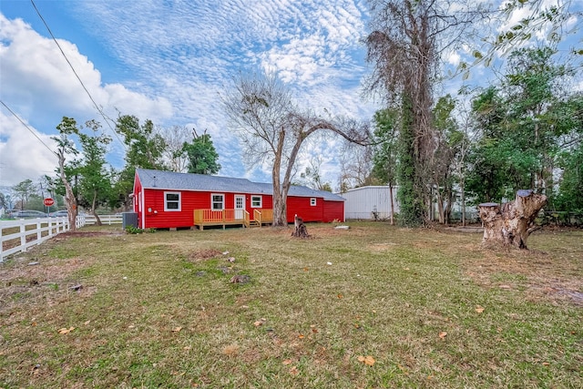 back of property with cooling unit and a lawn