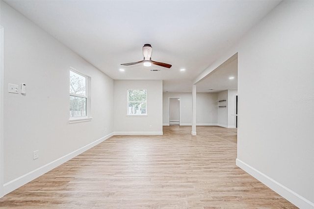 spare room with ceiling fan and light wood-type flooring