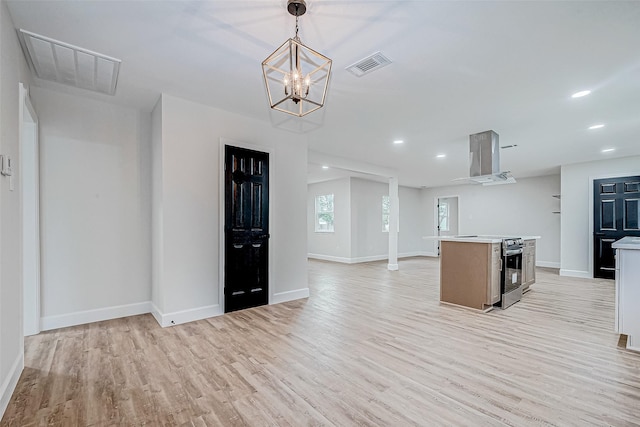 kitchen with extractor fan, hanging light fixtures, a kitchen island, stainless steel electric stove, and light hardwood / wood-style floors