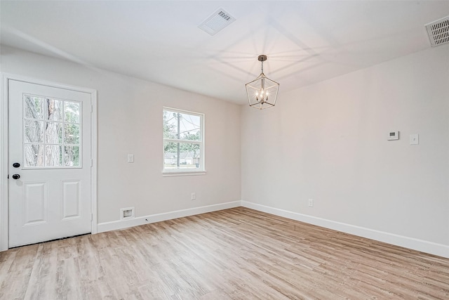 interior space with a notable chandelier and light wood-type flooring