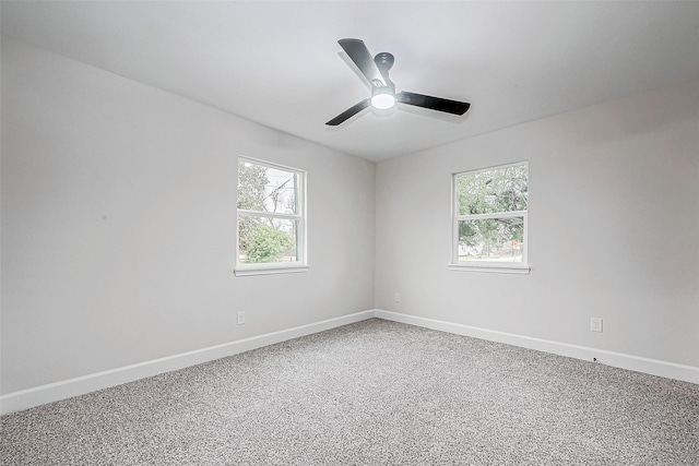 spare room with ceiling fan, a healthy amount of sunlight, and carpet flooring