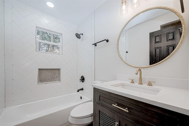 full bathroom with vanity, tiled shower / bath combo, and toilet