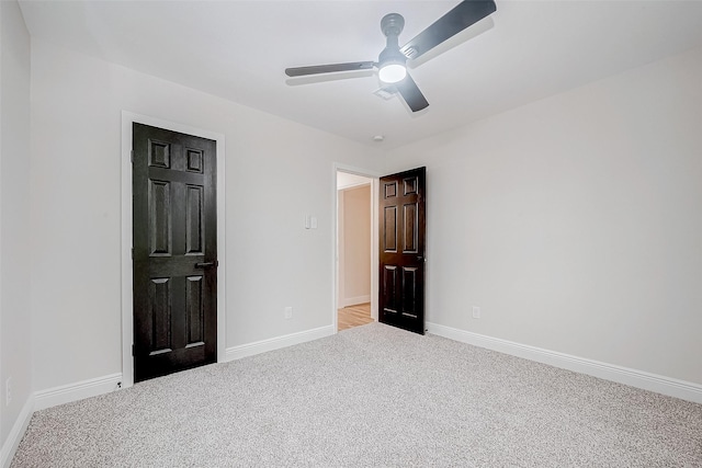 unfurnished bedroom featuring ceiling fan and light colored carpet