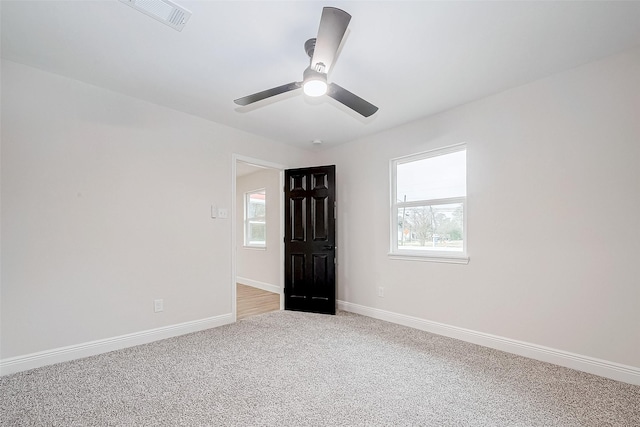 unfurnished bedroom with ceiling fan and light colored carpet