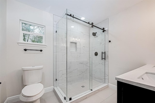 bathroom with vanity, a shower with shower door, tile patterned floors, and toilet