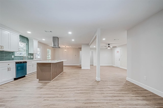 kitchen featuring light hardwood / wood-style flooring, dishwasher, white cabinets, a kitchen island, and exhaust hood