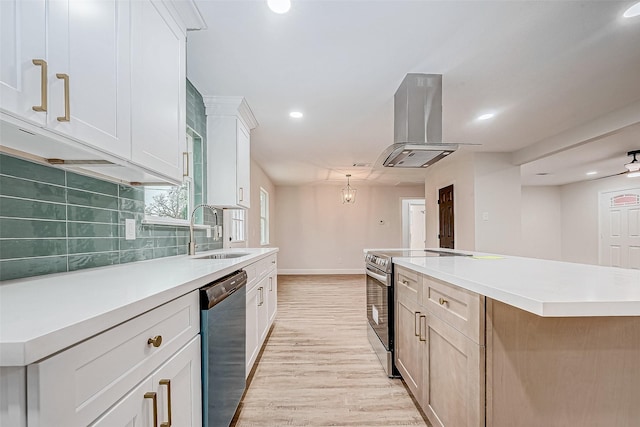 kitchen featuring a large island, sink, appliances with stainless steel finishes, white cabinetry, and island range hood