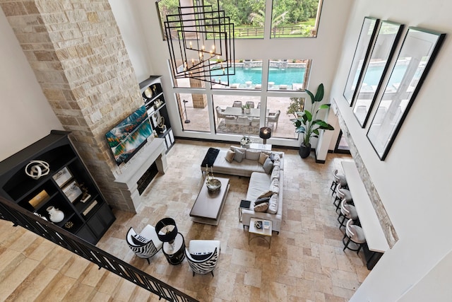 living room with a chandelier and a towering ceiling