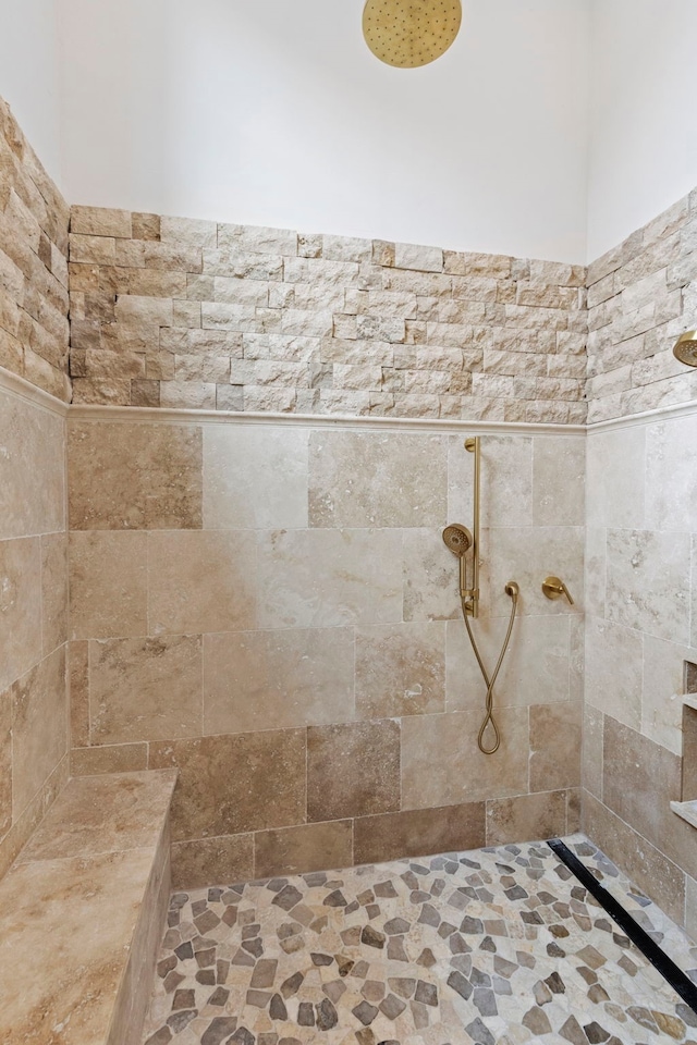 bathroom with a tile shower