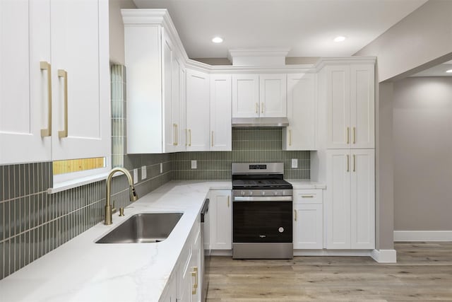 kitchen featuring white cabinetry, sink, stainless steel appliances, and light hardwood / wood-style floors