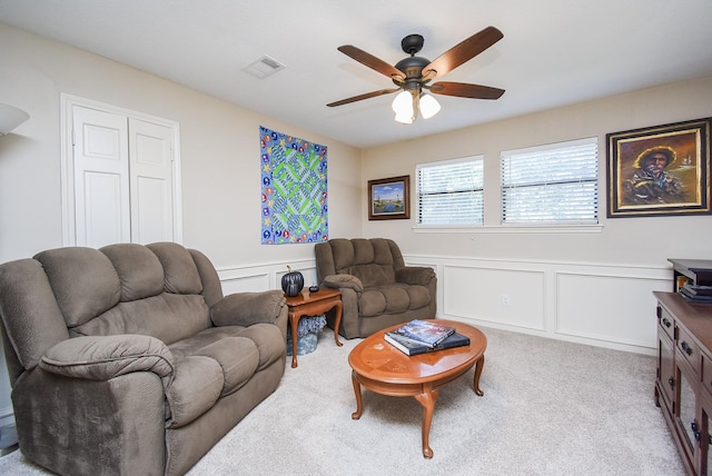 living room featuring light carpet and ceiling fan