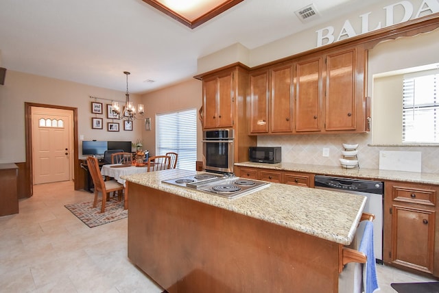 kitchen with a wealth of natural light, appliances with stainless steel finishes, a center island, and pendant lighting