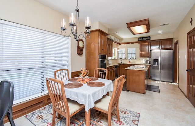 dining room featuring an inviting chandelier and sink