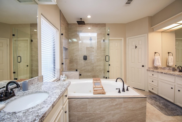 bathroom with vanity and shower with separate bathtub