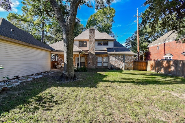 back of house with a lawn