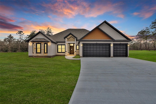 view of front of property featuring a garage and a lawn