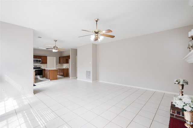 unfurnished living room featuring light tile patterned floors and ceiling fan