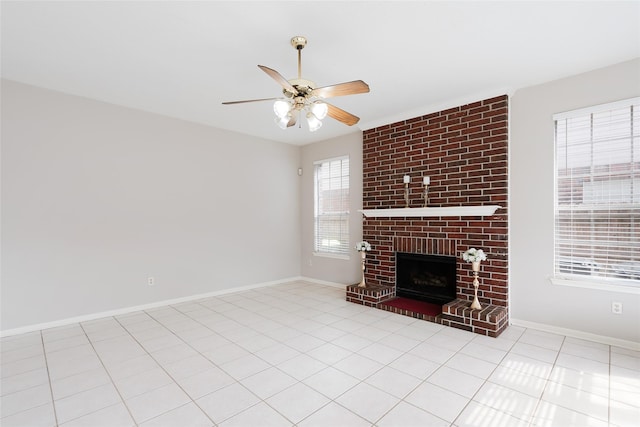 unfurnished living room featuring a fireplace, ceiling fan, and light tile patterned floors