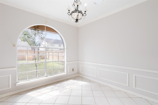 unfurnished room featuring light tile patterned floors, crown molding, and a notable chandelier