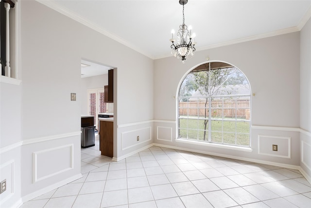 unfurnished dining area featuring ornamental molding, light tile patterned floors, and an inviting chandelier