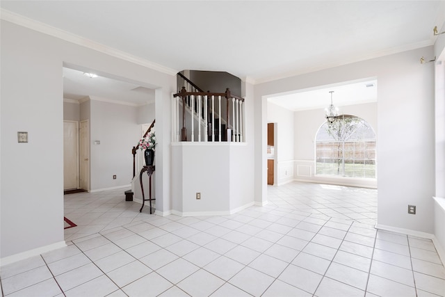 tiled empty room featuring crown molding and a notable chandelier