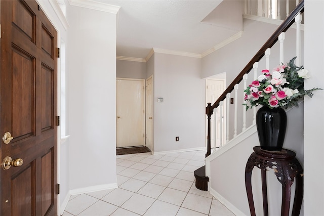 tiled entrance foyer featuring crown molding