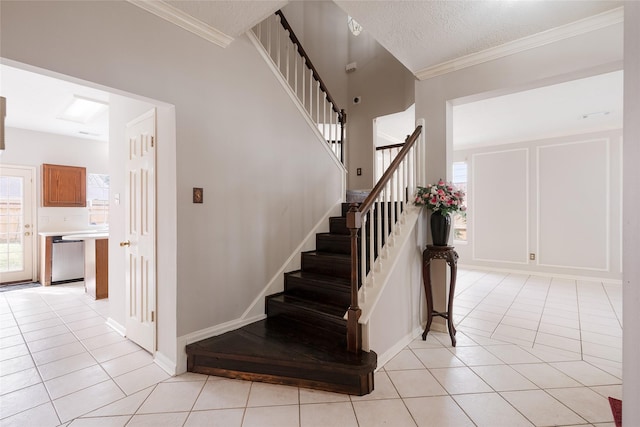 stairs featuring tile patterned floors, crown molding, and a textured ceiling