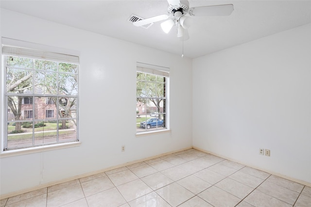 unfurnished room featuring ceiling fan and light tile patterned floors