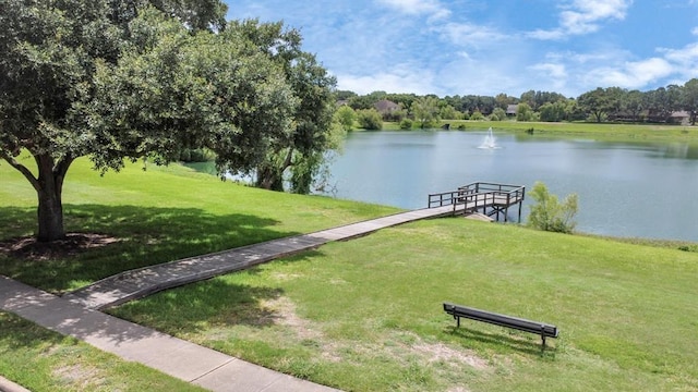 dock area with a water view and a lawn