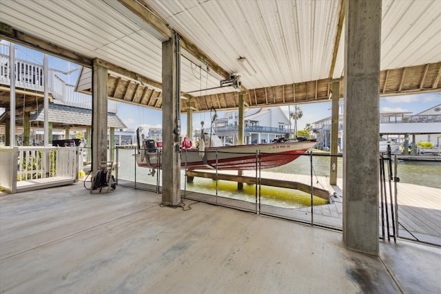 view of patio with a water view, a boat dock, and boat lift