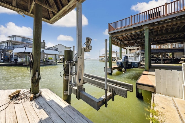 dock area with a water view and boat lift