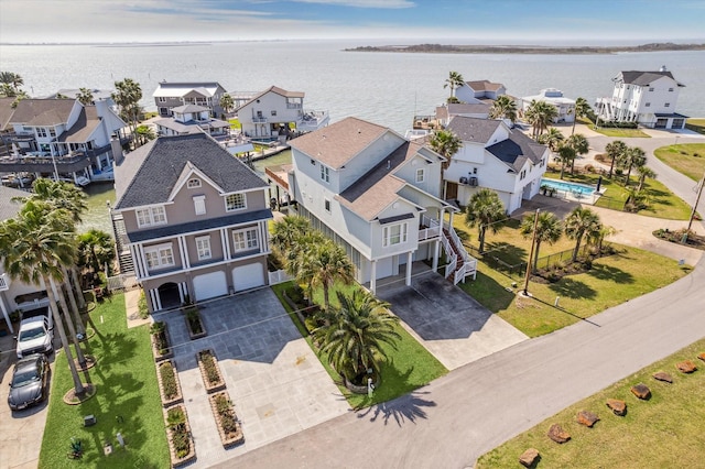 birds eye view of property featuring a water view and a residential view