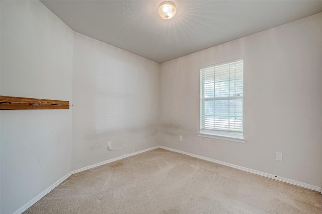 carpeted spare room with a textured ceiling