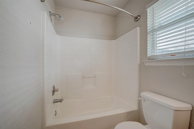 bathroom featuring bathtub / shower combination and toilet