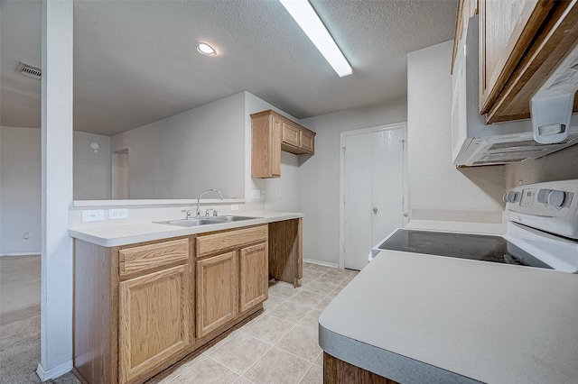 kitchen with sink, white appliances, light tile patterned floors, and a textured ceiling