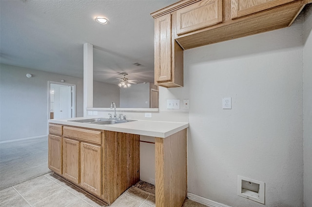 kitchen featuring ceiling fan, sink, light carpet, and light brown cabinets