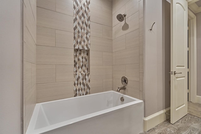 bathroom featuring shower / bathtub combination and baseboards