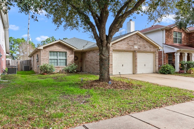 view of front of house with a garage, central air condition unit, and a front lawn