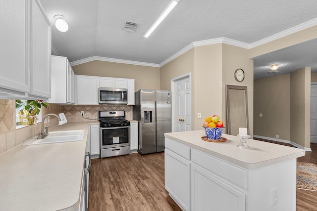 kitchen featuring white cabinetry, sink, a kitchen island, and appliances with stainless steel finishes