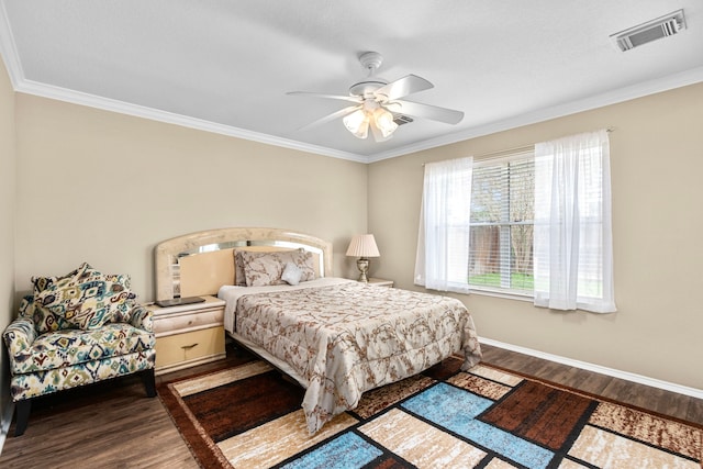 bedroom featuring crown molding, dark wood-type flooring, and ceiling fan