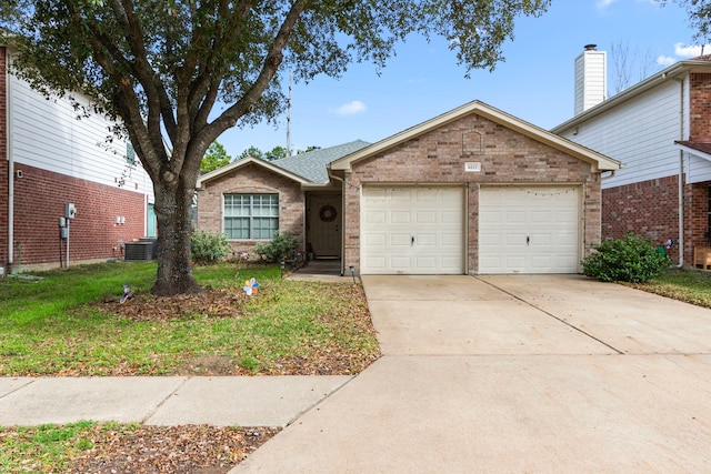 view of front of property with a garage, a front lawn, and central air condition unit