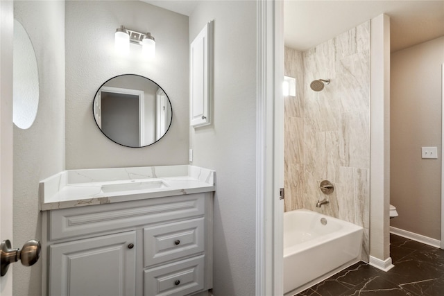 bathroom with marble finish floor, vanity, washtub / shower combination, and baseboards