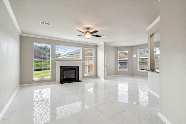 unfurnished living room featuring a healthy amount of sunlight, marble finish floor, baseboards, and visible vents