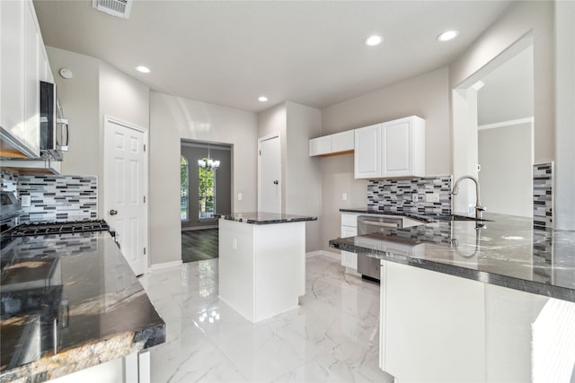 kitchen with visible vents, white cabinets, dark stone countertops, marble finish floor, and stainless steel appliances