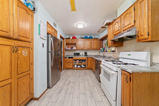 kitchen featuring sink, light wood-type flooring, and appliances with stainless steel finishes